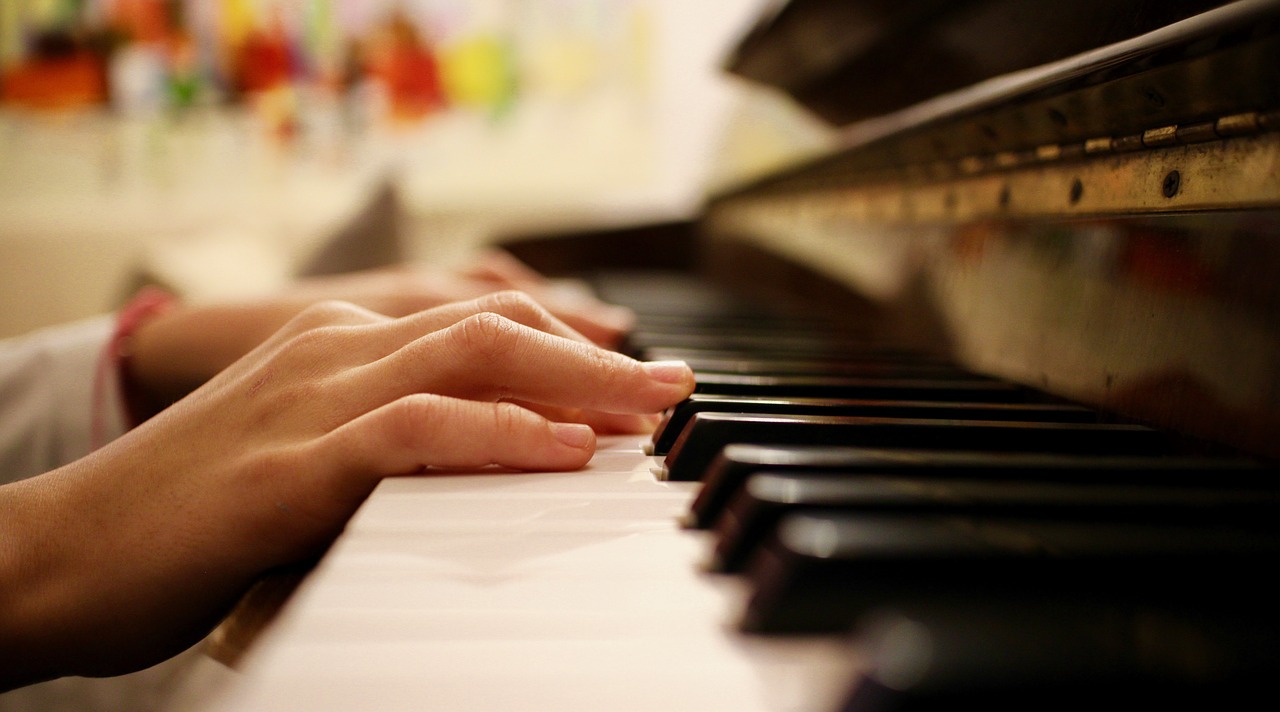 hands resting on top of piano